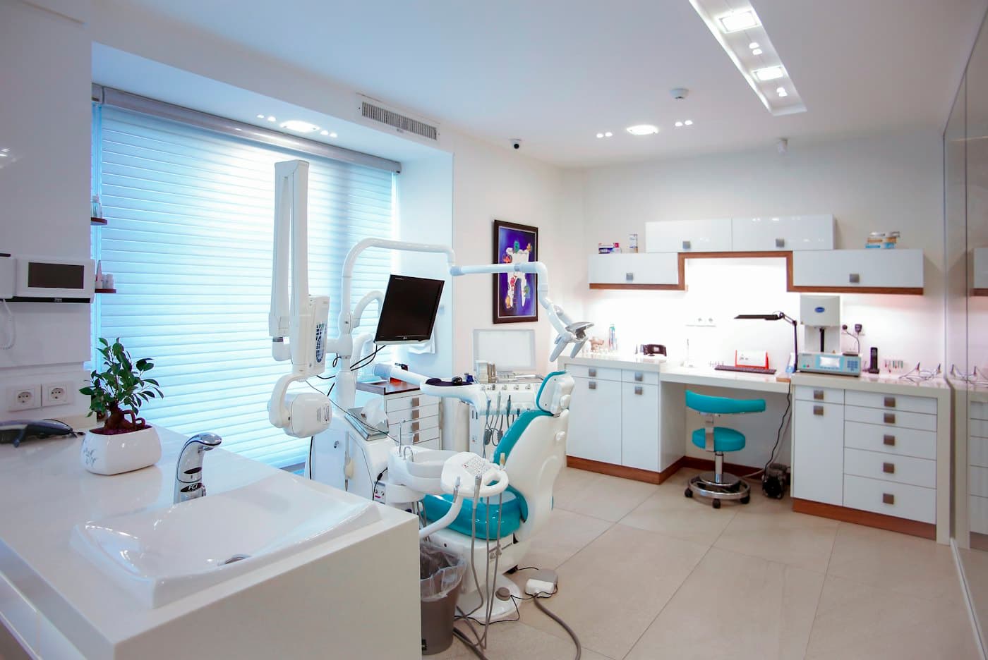 Quiet dental treatment room with an empty chair and clinical equipment
